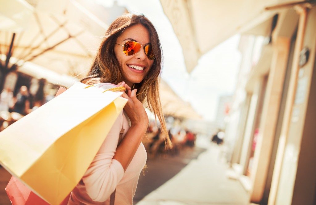 Happy woman holding her shopping bags